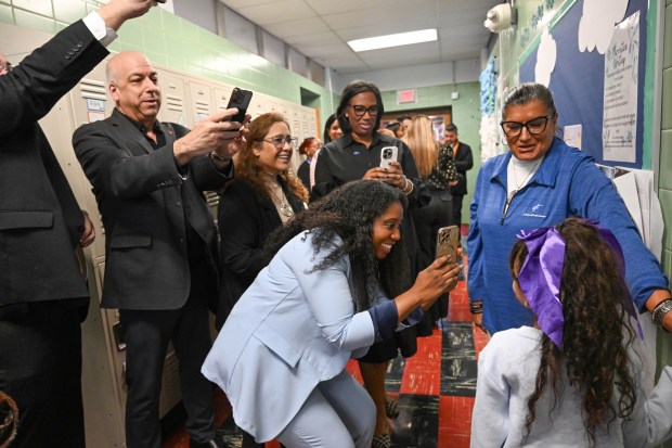 Sonia Sotomayor Dual Language Academy student Nelyanis shows off her picture in the hallway during a tour Thursday, Jan. 15, 2026, at the Allentown school sponsored by the American Federation of Teachers, the American Federation of Teachers Pennsylvania, the Allentown Federation of Paraprofessionals, the Labor Council for Latin American Advancement and the Allentown School District. State Rep. Peter Schweyer, D-Lehigh, was among those attending the event intended to highlight the contributions to the district by paraprofessionals and the local Latino community. (Amy Shortell/The Morning Call)