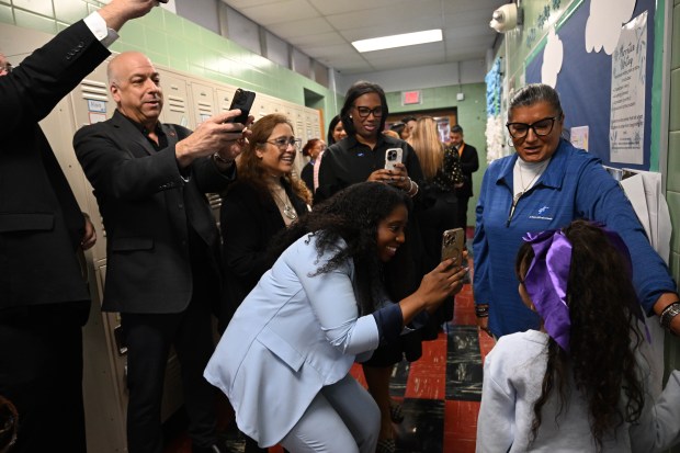 Sonia Sotomayor Dual Language Academy student Nelyanis shows off her picture in the hallway during a tour Thursday, Jan. 15, 2026, at the Allentown school sponsored by the American Federation of Teachers, the American Federation of Teachers Pennsylvania, the Allentown Federation of Paraprofessionals, the Labor Council for Latin American Advancement and the Allentown School District. State Rep. Peter Schweyer, D-Lehigh, was among those attending the event intended to highlight the contributions to the district by paraprofessionals and the local Latino community. (Amy Shortell/The Morning Call)