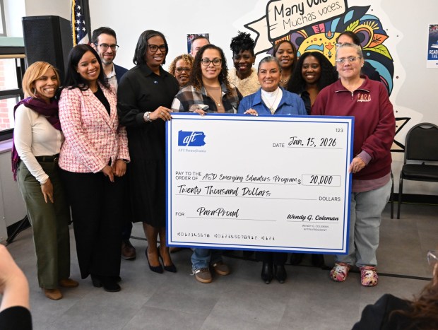 Allentown School District officials, American Federation of Teachers officials and local politicians take a picture with a check depicting the amount being donated to the district for scholarships for paraprofessionals Thursday, Jan. 15, 2026, at the Sonia Sotomayor Dual Language Academy in Allentown. (Amy Shortell/The Morning Call)