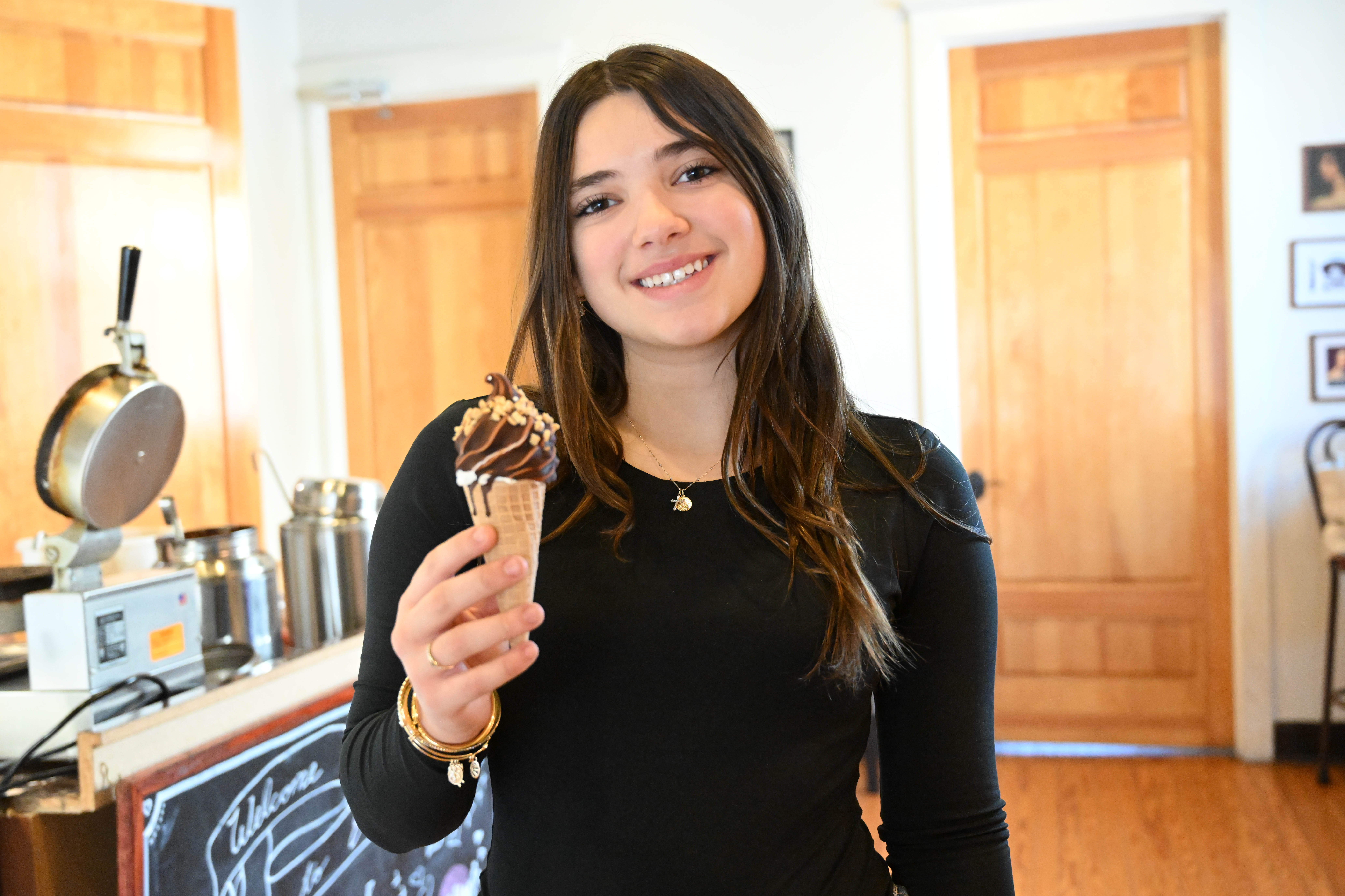 New Emily’s Ice Cream staff member Autumn Quercia holds an...