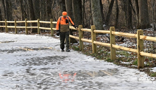 Tim Schneider of Whitehall Township navigates melting ice Wednesday, Jan. 7, 2026, on the Henry's Woods Trail at Jacobsburg state park in Bushkill Township. Schneider says he came to check out the trail for a day trip with his wife and that it is a really nice location.The high temperature reached into the 50s Wednesday, well above the average 30 degrees on Jan. 7. (Amy Shortell/The Morning Call)
