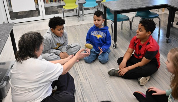 Ellen Siftar leads a game of hot potato Tuesday, Jan. 13, 2026, during 4-H at the Library at Parkland Community Library in South Whitehall Township. The program allows children to explore a range of topics through the 4-H curriculum, with each session offering a new theme, such as science experiments and robotics, art projects, healthy living, and agriculture. (Amy Shortell/The Morning Call)