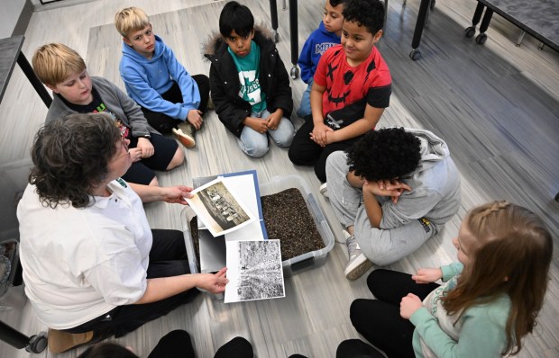Ellen Siftar shows pictures of how potatoes are harvested Tuesday, Jan. 13, 2026, during 4-H at the Library at Parkland Community Library in South Whitehall Township. The program allows children to explore a range of topics through the 4-H curriculum, with each session offering a new theme, such as science experiments and robotics, art projects, healthy living, and agriculture. (Amy Shortell/The Morning Call)
