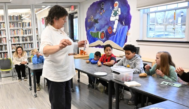 Zion Carmichael digs for a potato Tuesday, Jan. 13, 2026, during 4-H at the Library at Parkland Community Library in South Whitehall Township. The program allows children to explore a range of topics through the 4-H curriculum, with each session offering a new theme, such as science experiments and robotics, art projects, healthy living, and agriculture. (Amy Shortell/The Morning Call)