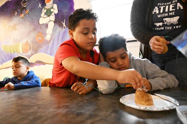 Maverick and Messiah Carmichael create a potato battery Tuesday, Jan. 13, 2026, during 4-H at the Library at Parkland Community Library in South Whitehall Township. The program allows children to explore a range of topics through the 4-H curriculum, with each session offering a new theme, such as science experiments and robotics, art projects, healthy living, and agriculture. (Amy Shortell/The Morning Call)