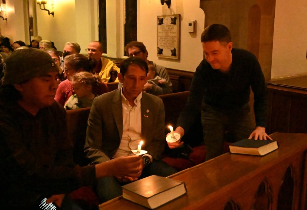 Allentown Mayor Matt Tuerk lights his candle with others as he attend sa vigil for Renee Nicole Good, the woman shot and killed by a federal immigration agent in Minneapolis, on Friday, Jan. 9, 2026, at the Cathedral Church of the Nativity in Bethlehem. (Amy Shortell/The Morning Call)