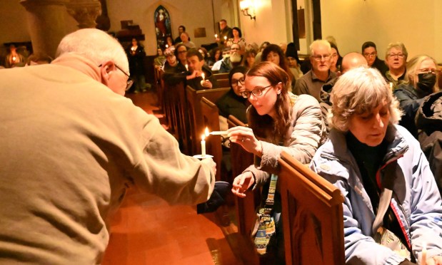 People attend a vigil for Renee Nicole Good, the woman shot and killed by a federal immigration agent in Minneapolis, on Friday, Jan. 9, 2026, at the Cathedral Church of the Nativity in Bethlehem. (Amy Shortell/The Morning Call)