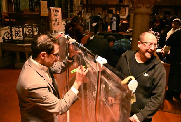 People attend a vigil for Renee Nicole Good, the woman shot and killed by a federal immigration agent in Minneapolis, on Friday, Jan. 9, 2026, at the Cathedral Church of the Nativity in Bethlehem. (Amy Shortell/The Morning Call)