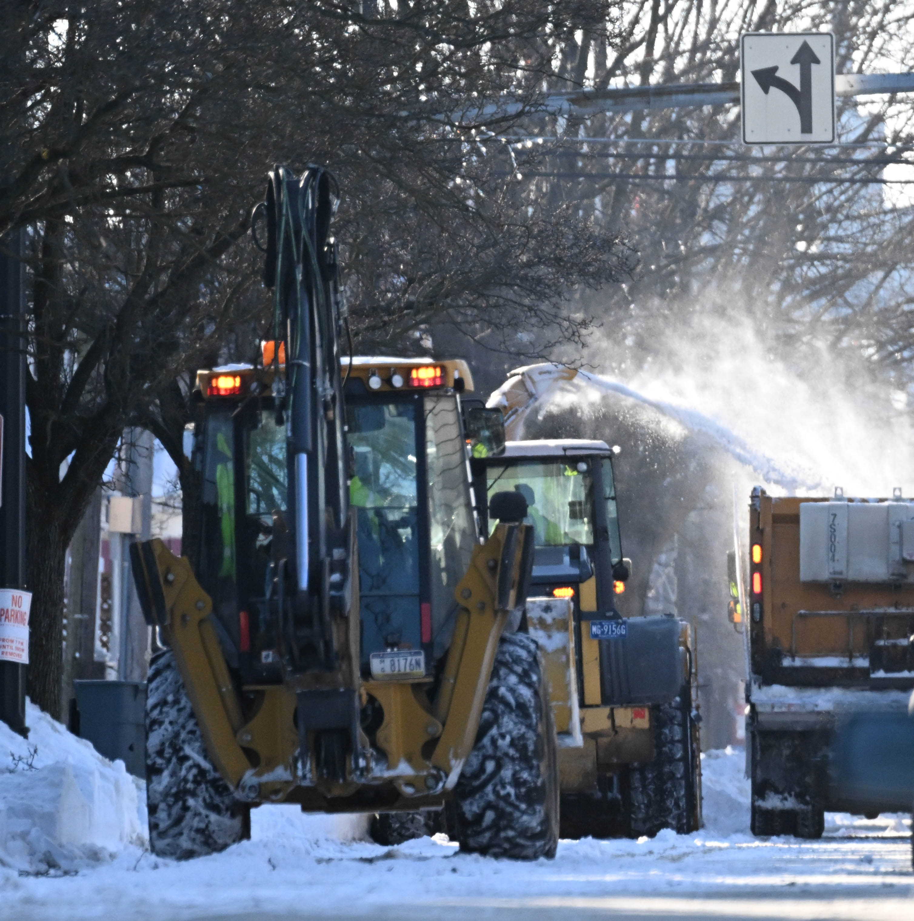 Workers from the Allentown Public Works Department clear snow from...