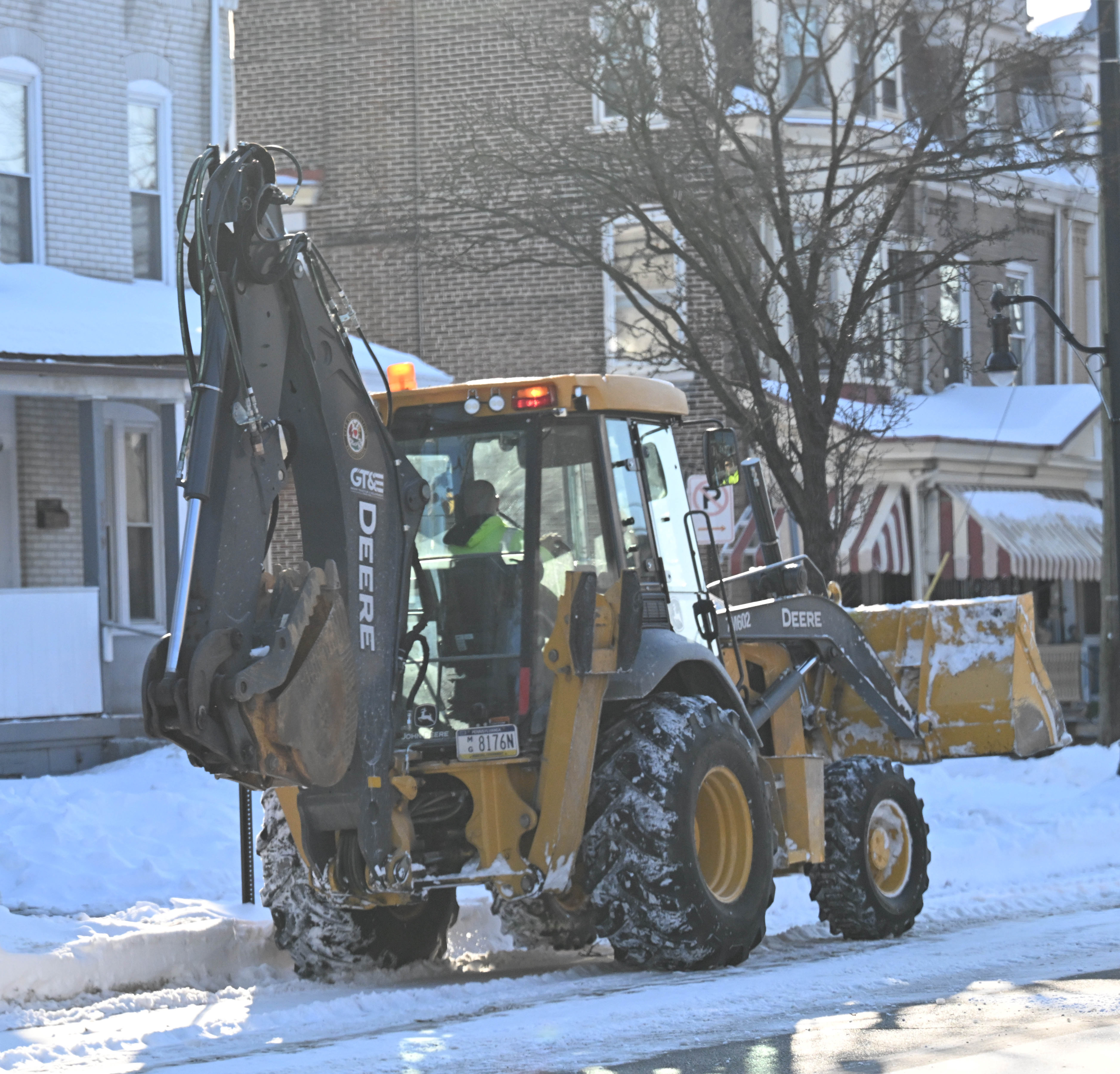 Workers from the Allentown Public Works Department clear snow from...