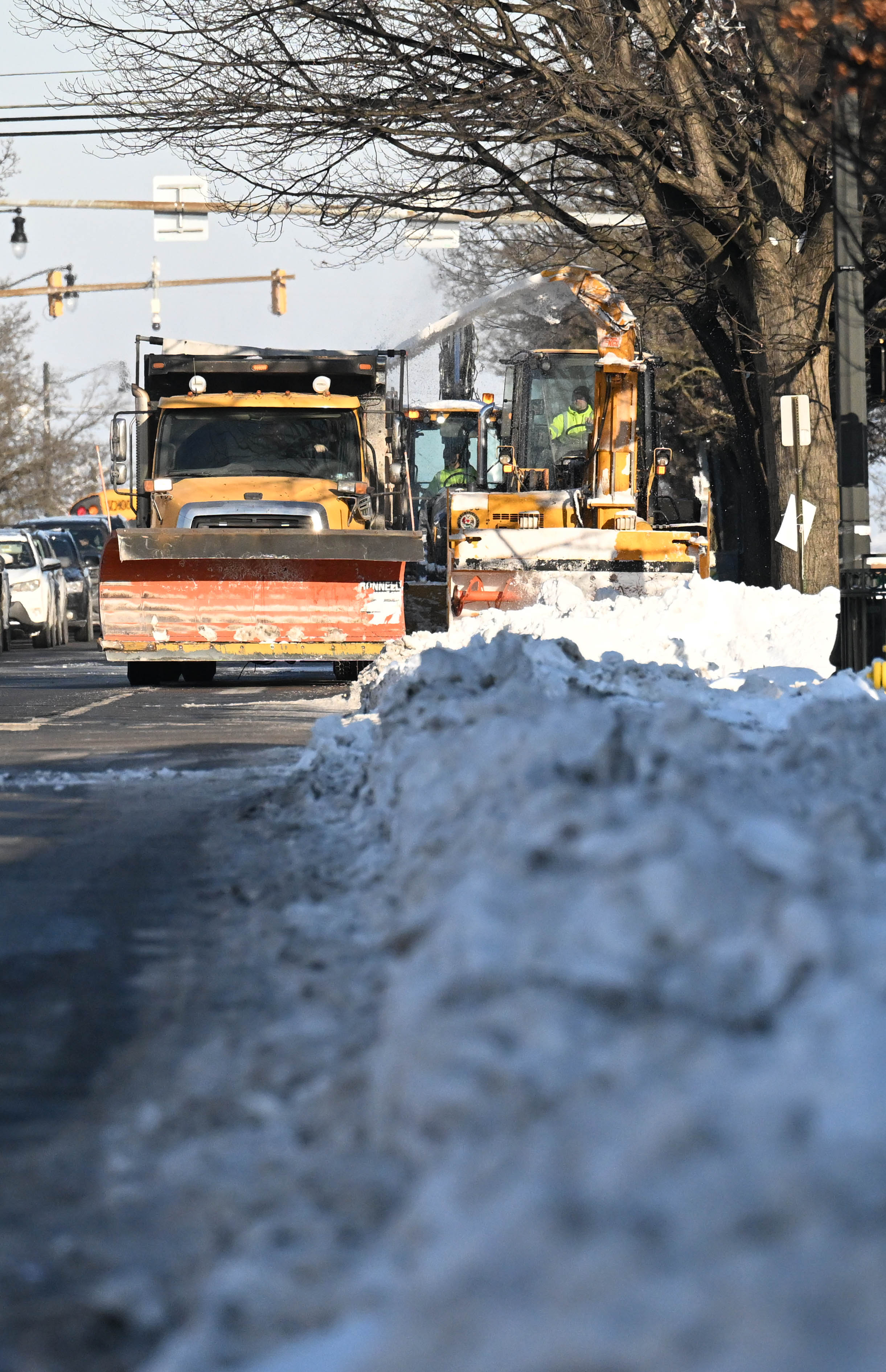 Workers from the Allentown Public Works Department clear snow from...
