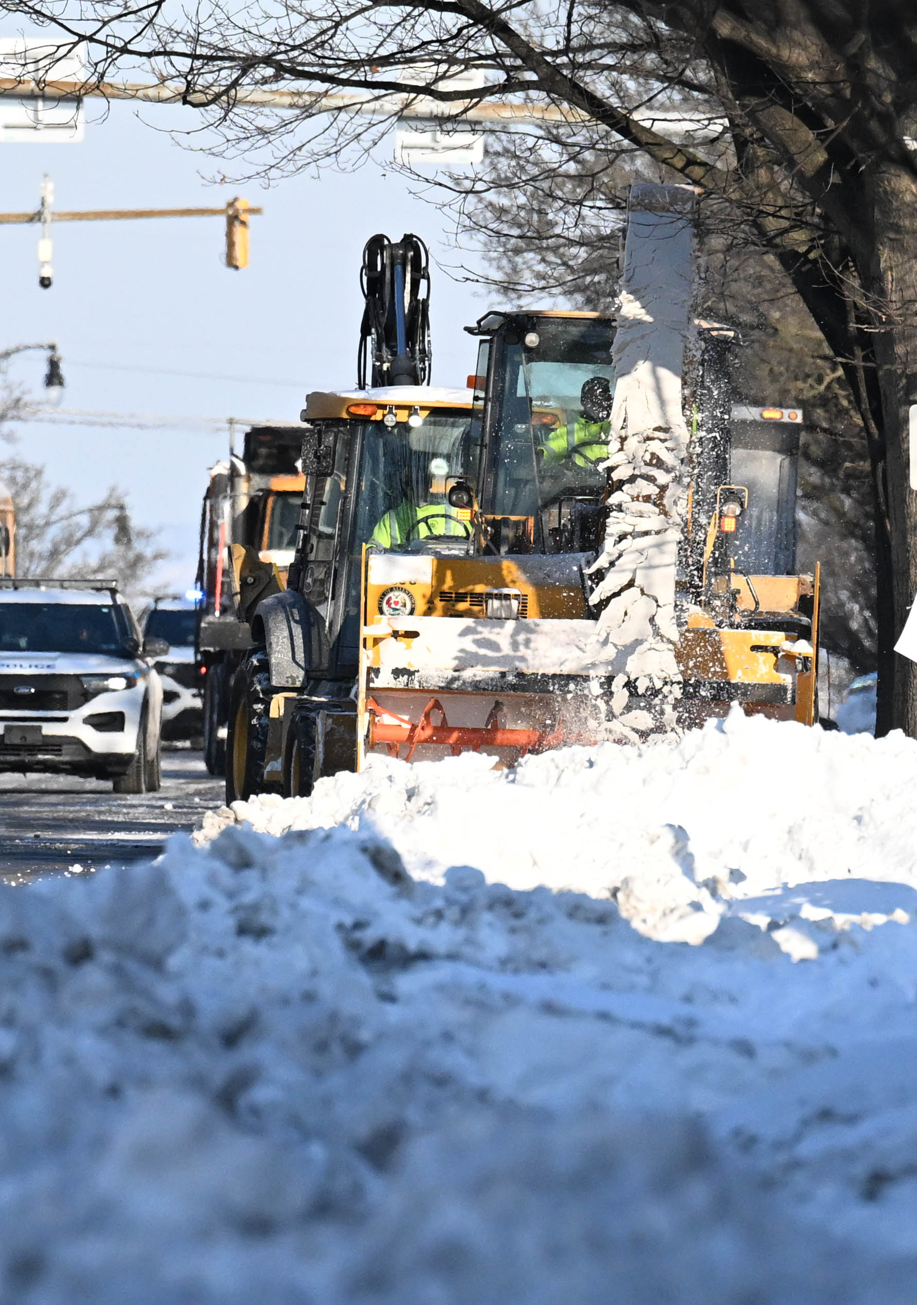Workers from the Allentown Public Works Department clear snow from...