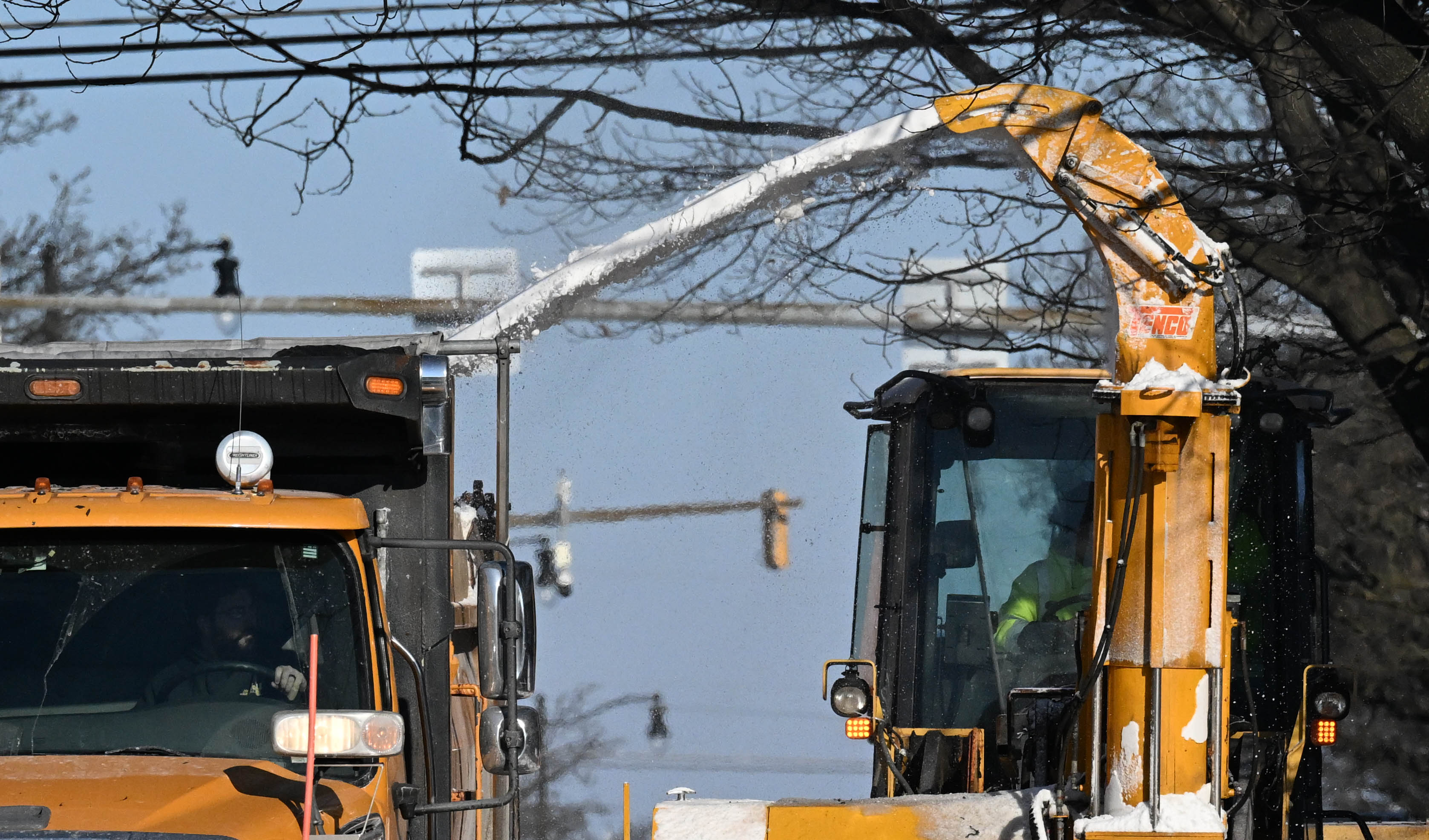 Workers from the Allentown Public Works Department clear snow from...