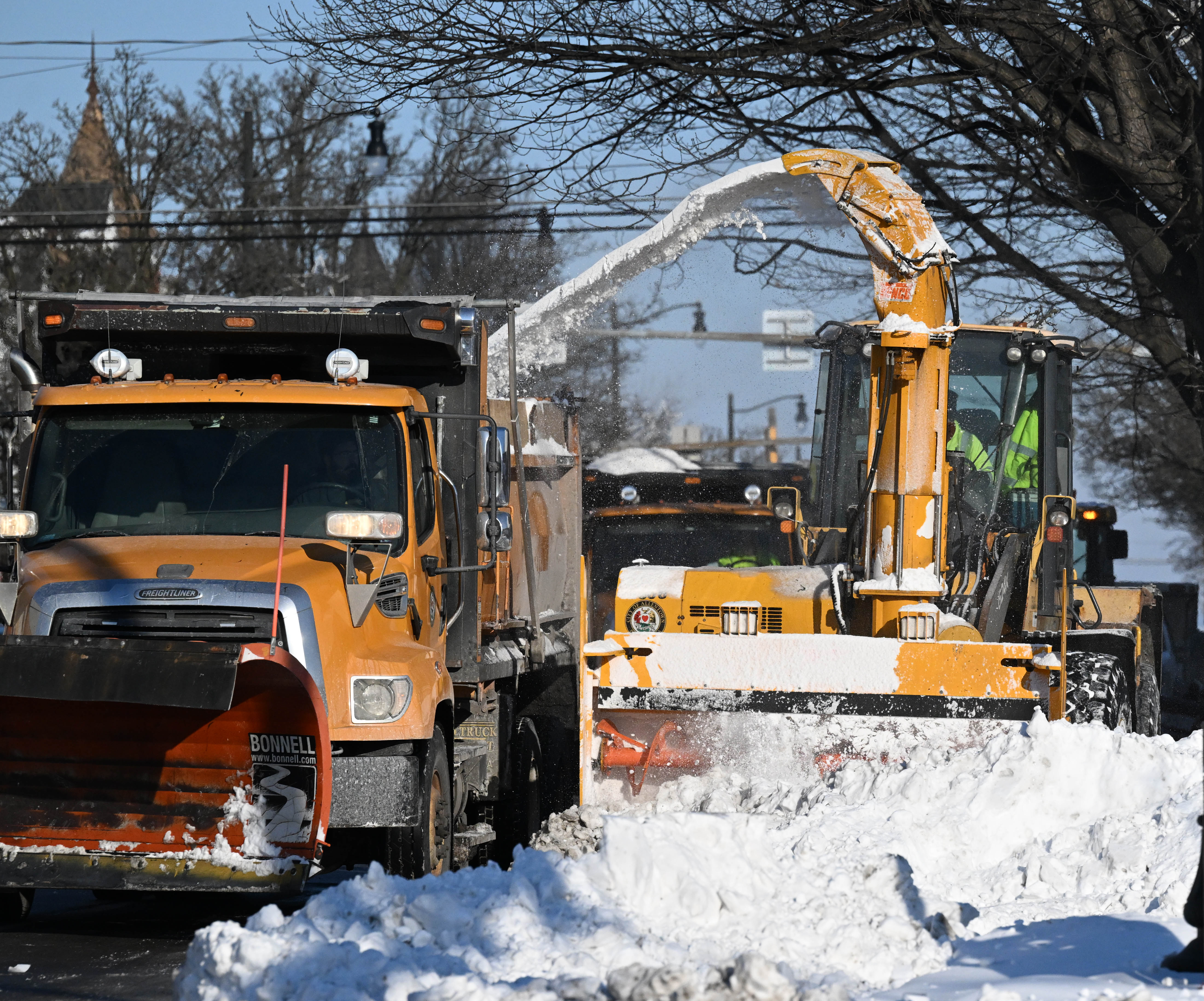 Workers from the Allentown Public Works Department clear snow from...