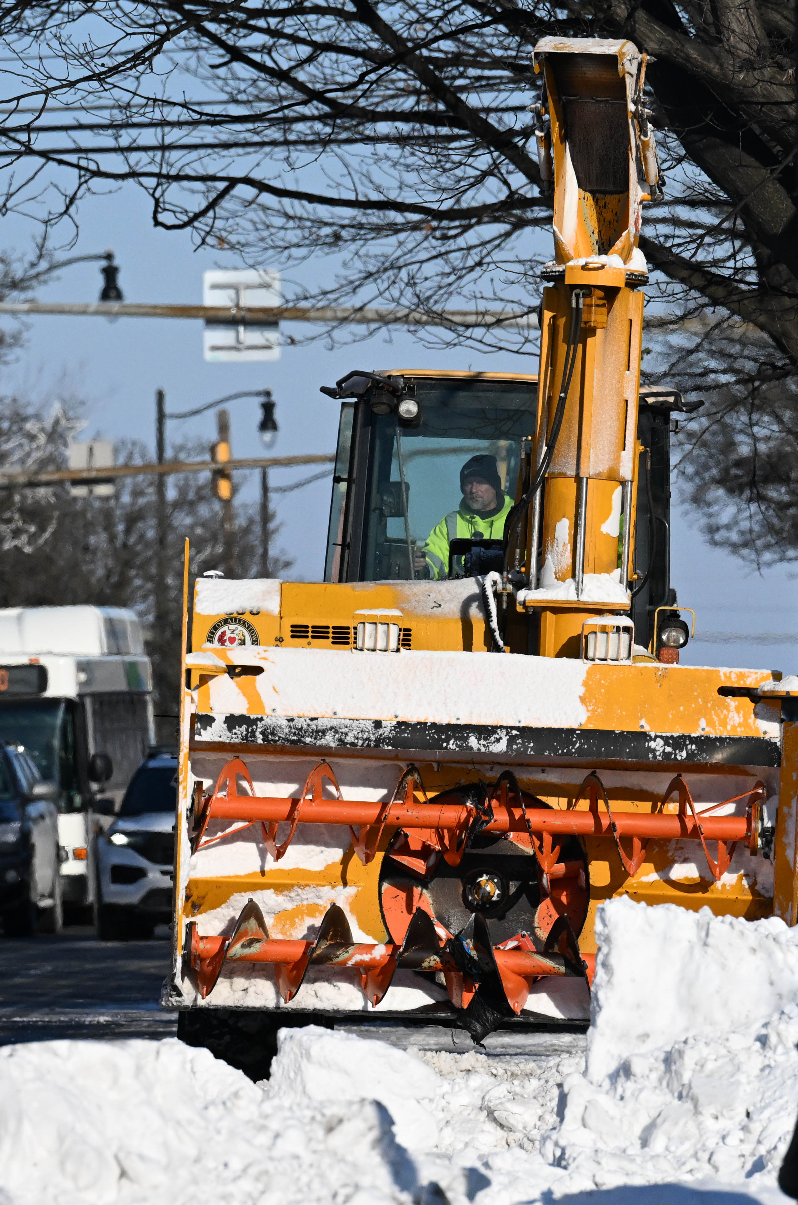 Workers from the Allentown Public Works Department clear snow from...