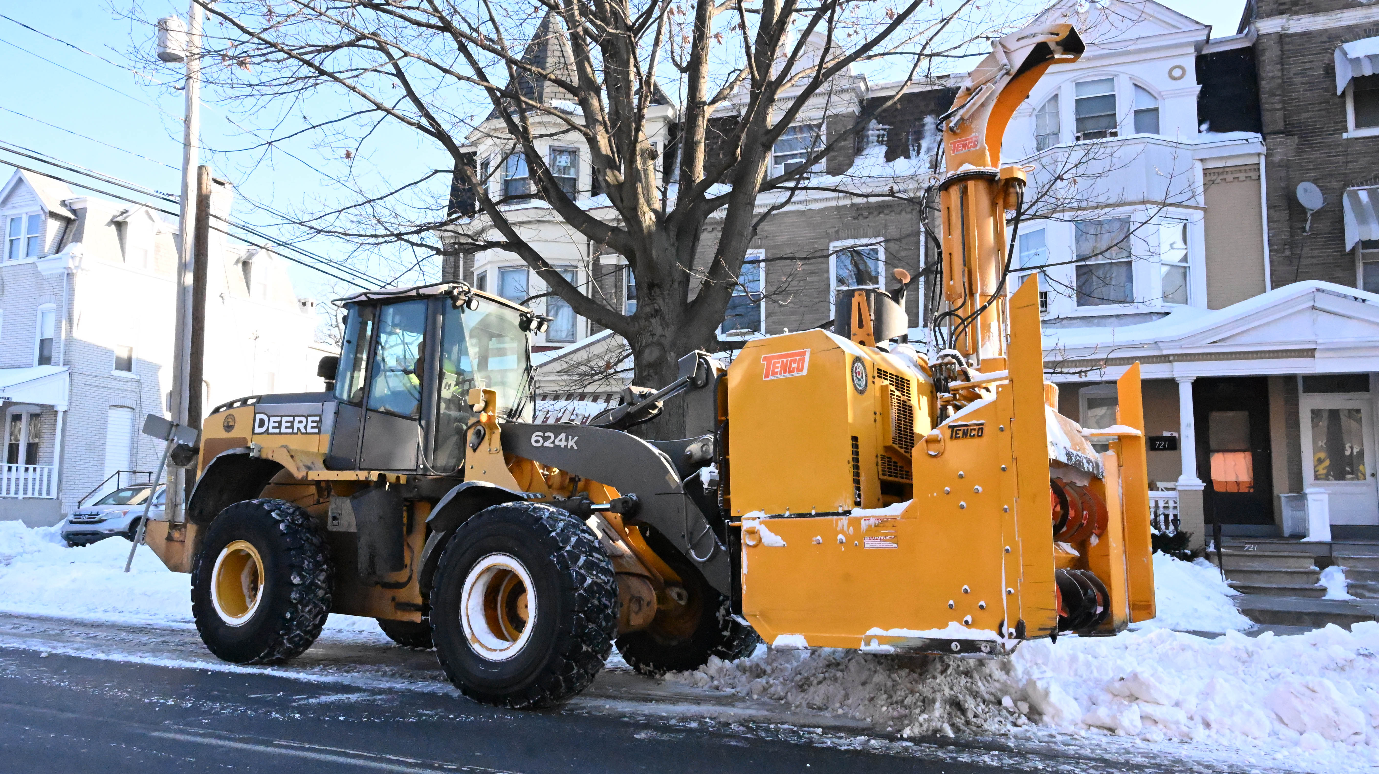 Workers from the Allentown Public Works Department clear snow from...