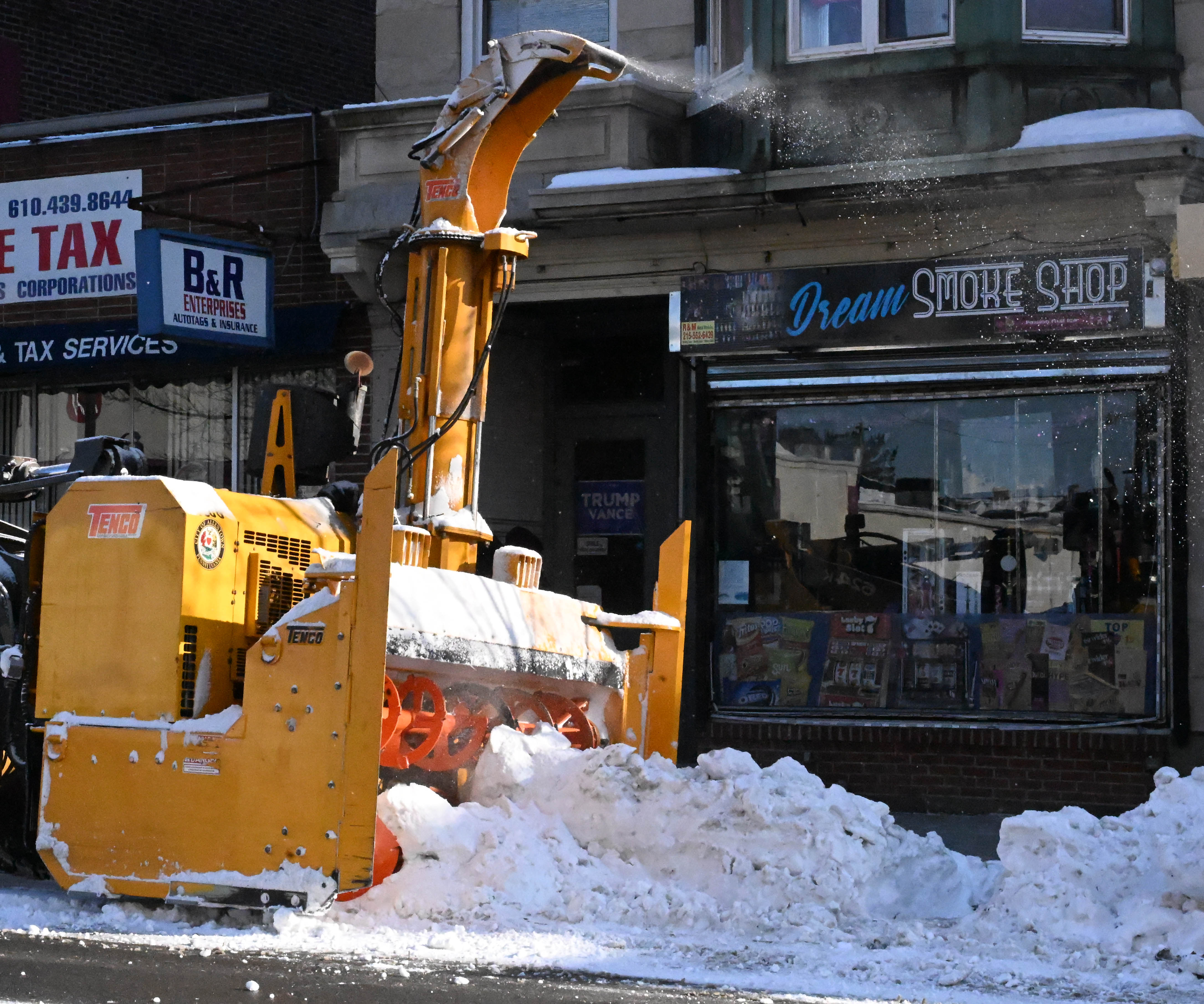 Workers from the Allentown Public Works Department clear snow from...