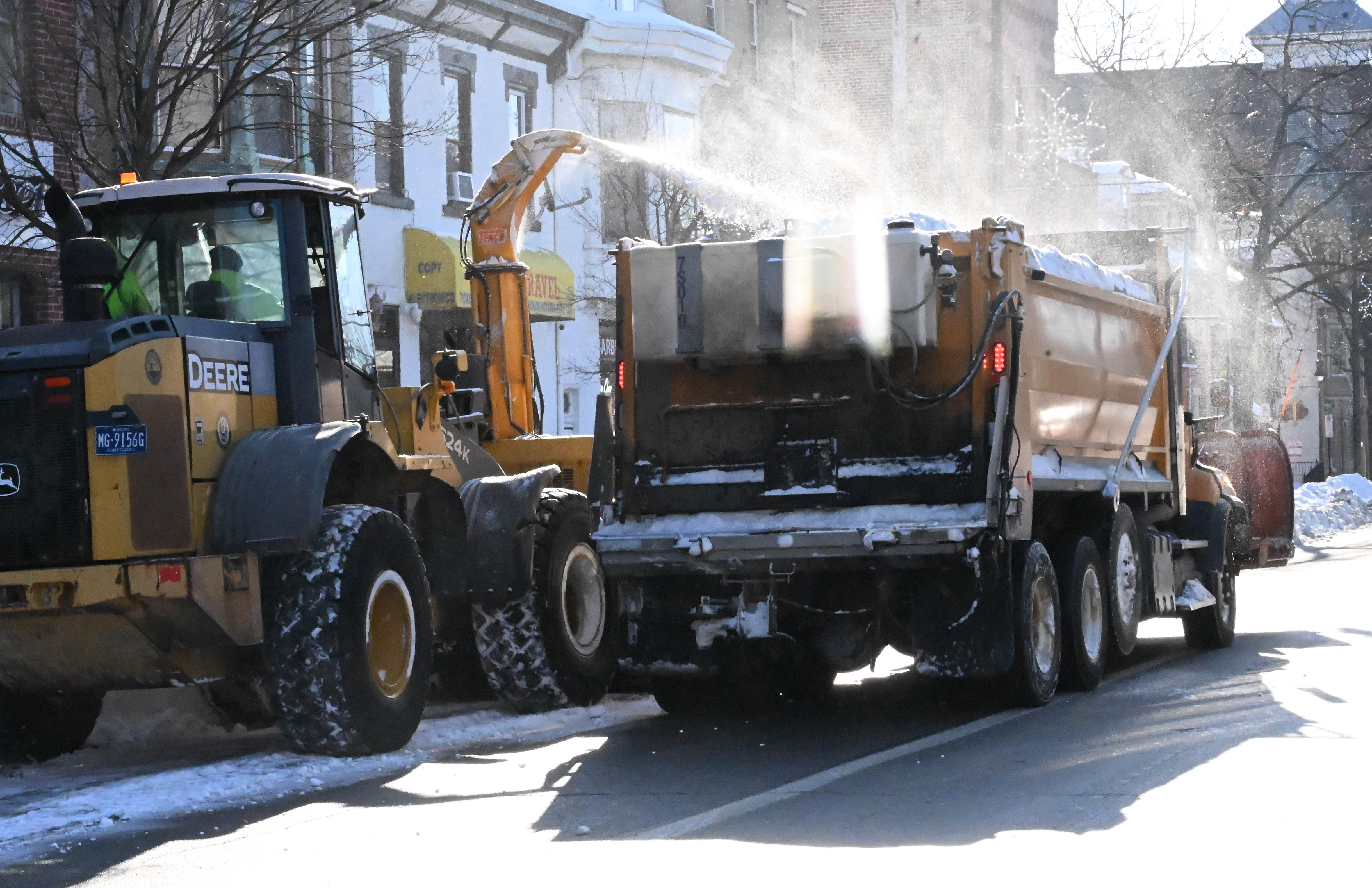 Workers from the Allentown Public Works Department clear snow from...