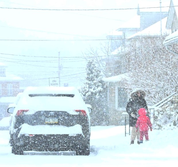 Pedestrians walk in the snow Saturday, Jan. 17, 2026, in Northampton. A winter storm dropped several inches of snow across the Lehigh Valley, leading to messy travel conditions.(Amy Shortell / The Morning Call)
