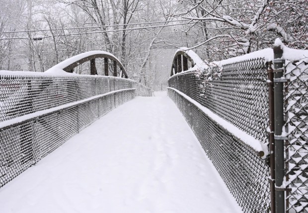 The bridge crossing the Hokendauqua Creek along the D&L Trail is covered in snow Saturday, Jan. 17, 2026, in Northampton. A winter storm dropped several inches of snow across the Lehigh Valley, leading to messy travel conditions.(Amy Shortell / The Morning Call)