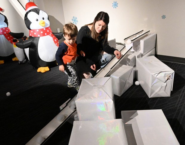 William Oplinger, 2,of Phoenixville, plays with snowballs in a tube maze with his mother Somer Wiggins Friday, Jan. 2, 2026, in the Winter Wonder Lab exhibit at the Da Vinci Science Center in Allentown. (Amy Shortell/The Morning Call)