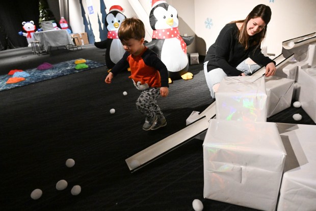 William Oplinger, 2,of Phoenixville, plays with snowballs in a tube maze with his mother Somer Wiggins Friday, Jan. 2, 2026, in the Winter Wonder Lab exhibit at the Da Vinci Science Center in Allentown. (Amy Shortell/The Morning Call)