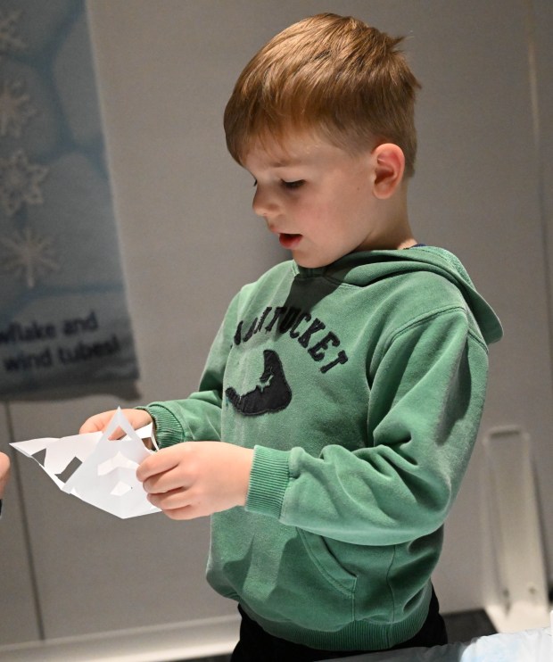 Henry Beck,5, creates a paper snowflake Friday, Jan. 2, 2026, in the Winter Wonder Lab exhibit at the Da Vinci Science Center in Allentown. (Amy Shortell/The Morning Call)