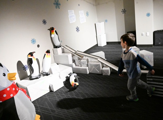 Mason Ridilla,3, throws snowballs trying to knock penguins over Friday, Jan. 2, 2026, in the Winter Wonder Lab exhibit at the Da Vinci Science Center in Allentown. (Amy Shortell/The Morning Call)