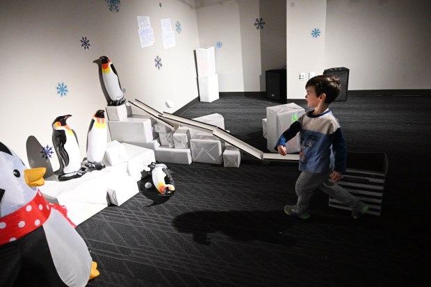 Mason Ridilla,3, throws snowballs trying to knock penguins over Friday, Jan. 2, 2026, in the Winter Wonder Lab exhibit at the Da Vinci Science Center in Allentown. (Amy Shortell/The Morning Call)