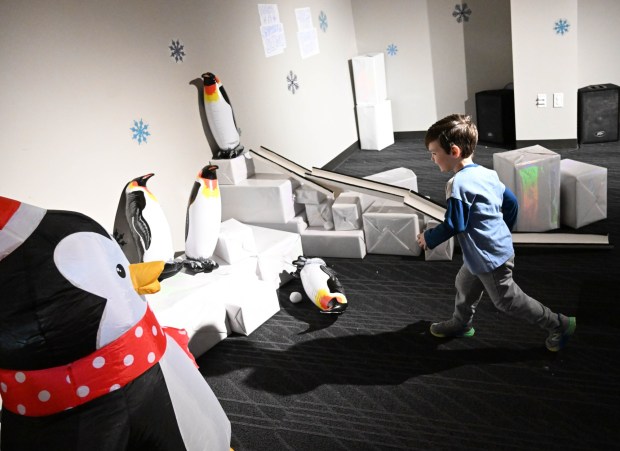 Mason Ridilla,3, throws snowballs trying to knock penguins over Friday, Jan. 2, 2026, in the Winter Wonder Lab exhibit at the Da Vinci Science Center in Allentown. (Amy Shortell/The Morning Call)