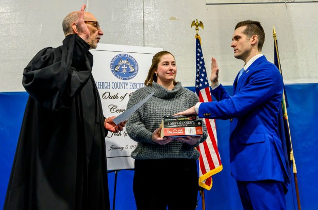 Lehigh County President Judge Douglas G. Reichley administers the oath of office to new Lehigh County Executive Josh Siegel, standing with his wife, Sara, on Monday, Jan. 5, 2026, at The Boys and Girls Club of Allentown Cumberland Gardens Clubhouse. (April Gamiz / The Morning Call)
