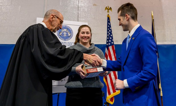 Lehigh County President Judge Douglas G. Reichley administers the oath of office to new Lehigh County Executive Josh Siegel, standing with his wife, Sara, on Monday, Jan. 5, 2026, at The Boys and Girls Club of Allentown Cumberland Gardens Clubhouse. (April Gamiz / The Morning Call)