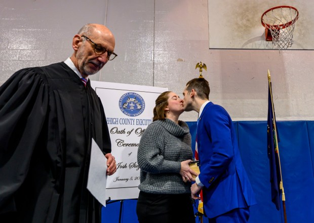 Lehigh County President Judge Douglas G. Reichley administers the oath of office to new Lehigh County Executive Josh Siegel, standing with his wife, Sara, on Monday, Jan. 5, 2026, at The Boys and Girls Club of Allentown Cumberland Gardens Clubhouse. (April Gamiz / The Morning Call)