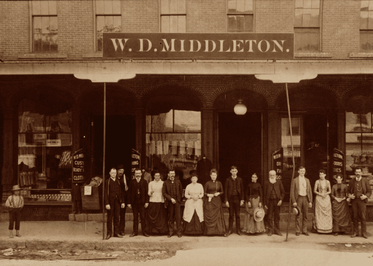 Employees and boy in front of clothing store