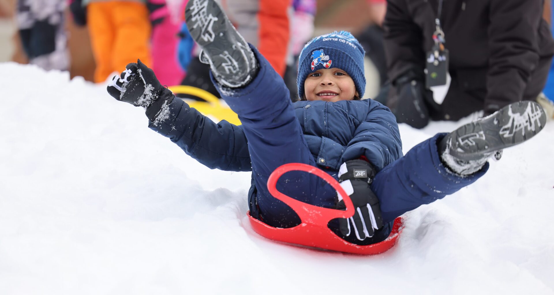 student on a sled in snow