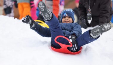student on a sled in snow