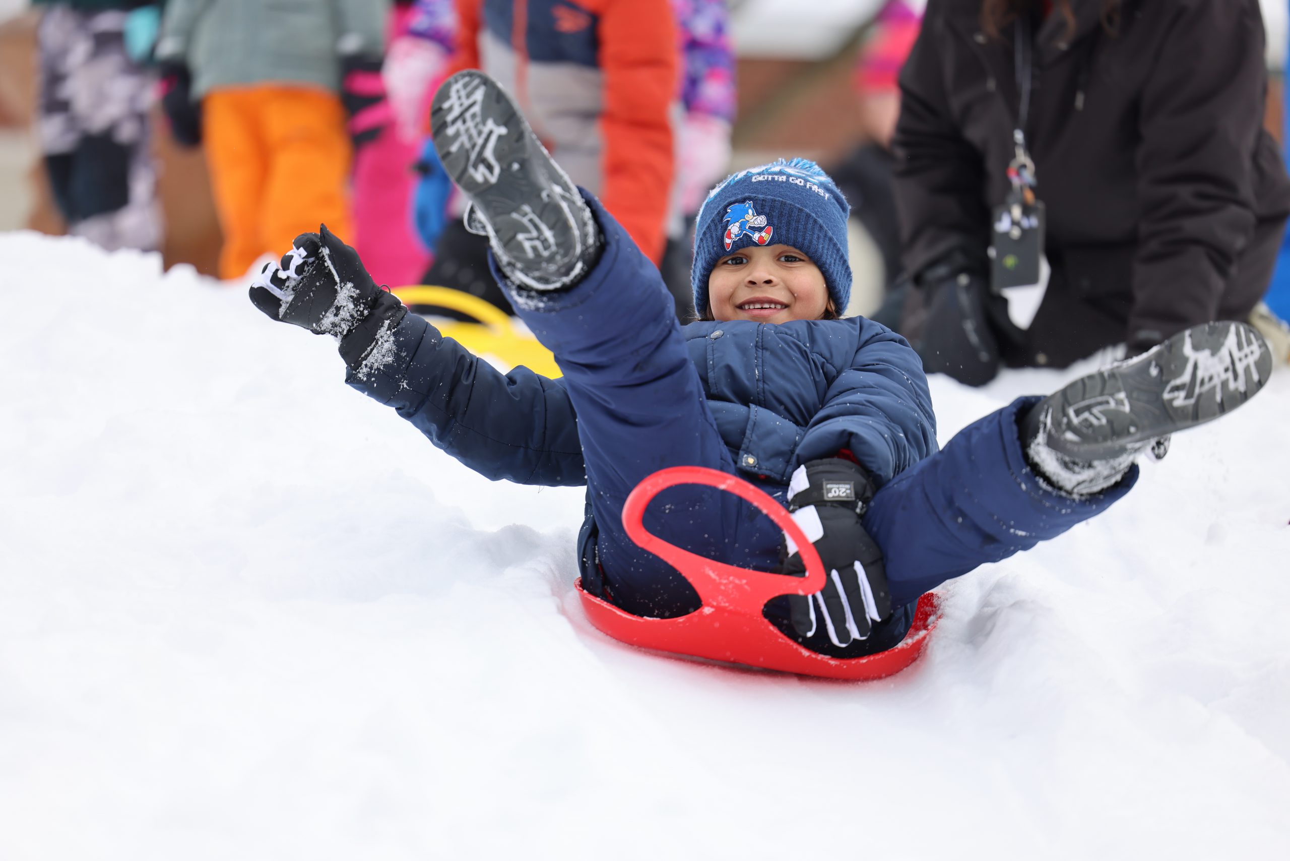 student on a sled in snow
