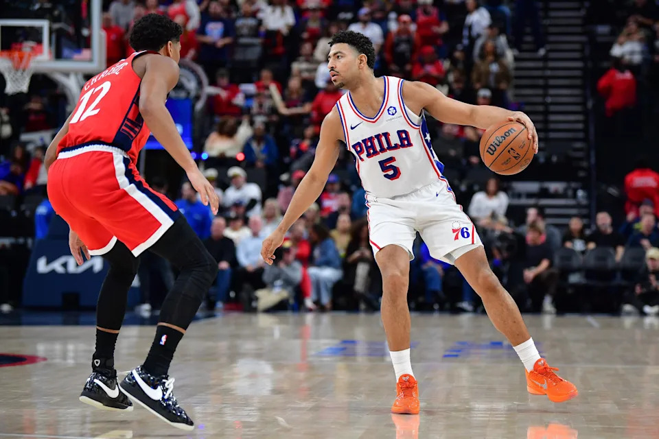 Feb 2, 2026; Inglewood, California, USA; Philadelphia 76ers guard Quentin Grimes (5) controls the ball against Los Angeles Clippers guard Cam Christie (12) during the second half at Intuit Dome. Mandatory Credit: Gary A. Vasquez-Imagn Images