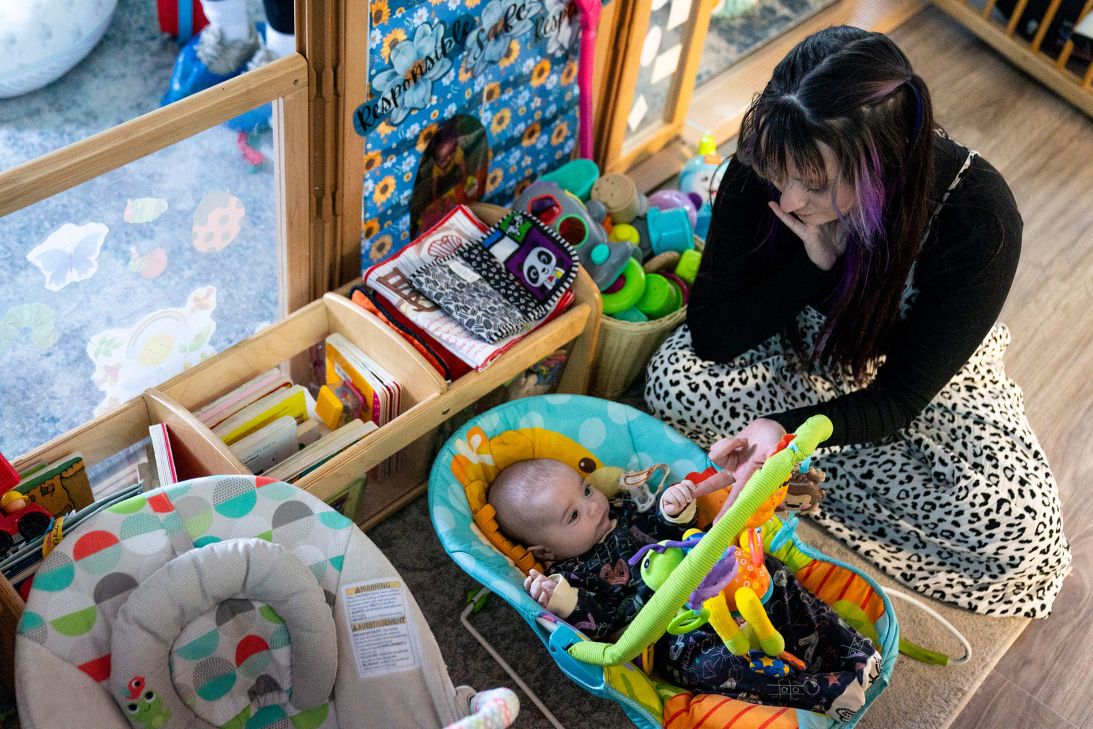 A staff member checks on her own infant between her responsibilites in other parts of the facilty at Active Learning Centers Emmaus in Emmaus, Pennsylvania, on Friday, January 30.