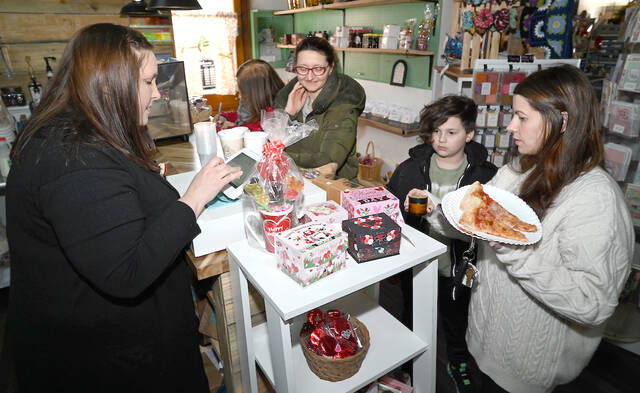 <p>Kellyann Kenny, far right, purchases a candle from The Crooked Branch.</p>
<p>Tony Callaio | For Sunday Dispatch</p>