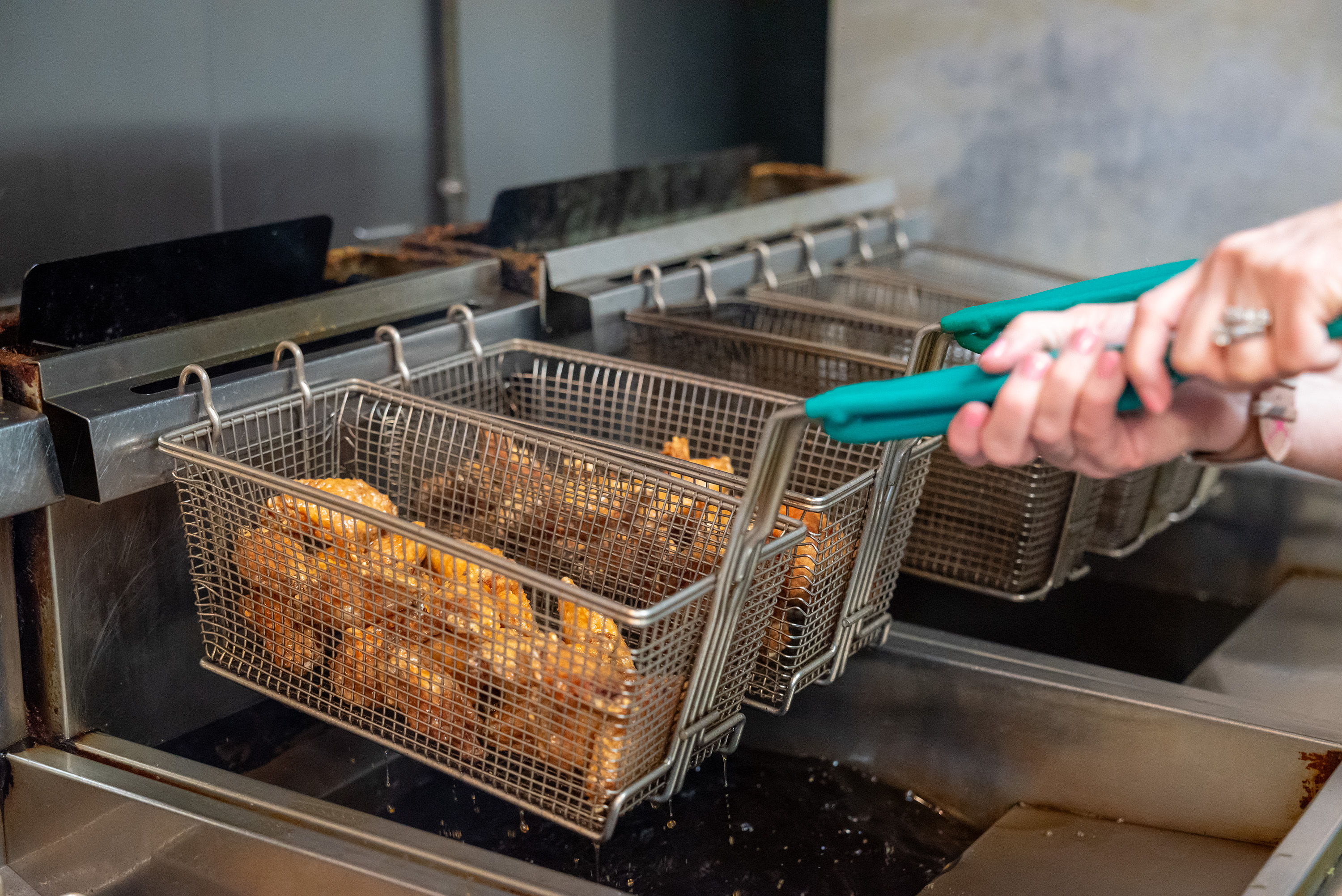 Wings come out of the fryer at Kelly’s Pub and...