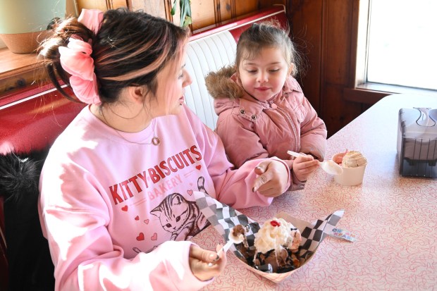 Cassie Velders and her daughter, Luna, 4, enjoy a waffle sundae and a bowl of ice cream Saturday, Feb. 7, 2026, at Inside Scoop in Coopersburg. The shop featured special ice cream dishes to celebrate National Ice Cream for Breakfast Day. (Amy Shortell/The Morning Call)