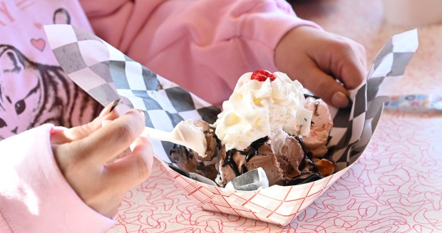 Cassie Velders and her daughter, Luna, 4, enjoy a waffle sundae and a bowl of ice cream Saturday, Feb. 7, 2026, at Inside Scoop in Coopersburg. The shop featured special ice cream dishes to celebrate National Ice Cream for Breakfast Day. (Amy Shortell/The Morning Call)