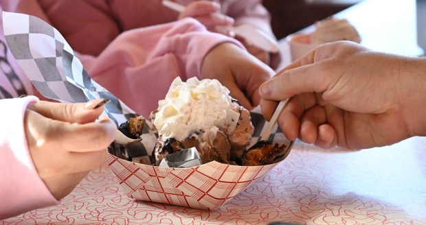 Cassie Velders and her daughter, Luna, 4, enjoy a waffle sundae and a bowl of ice cream Saturday, Feb. 7, 2026, at Inside Scoop in Coopersburg. The shop featured special ice cream dishes to celebrate National Ice Cream for Breakfast Day. (Amy Shortell/The Morning Call)