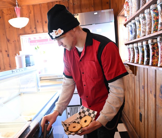 Dylan Garcia creates a doughnut sundae Saturday, Feb. 7, 2026, at Inside Scoop in Coopersburg. The shop featured special ice cream dishes to celebrate National Ice Cream for Breakfast Day. (Amy Shortell/The Morning Call)