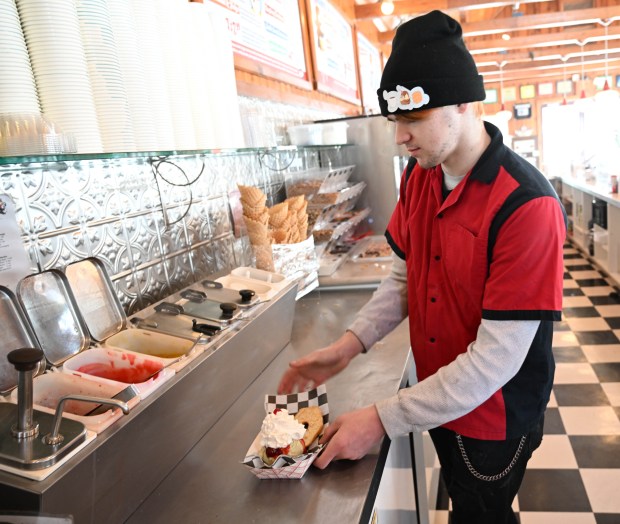 Dylan Garcia creates a doughnut sundae Saturday, Feb. 7, 2026, at Inside Scoop in Coopersburg. The shop featured special ice cream dishes to celebrate National Ice Cream for Breakfast Day. (Amy Shortell/The Morning Call)