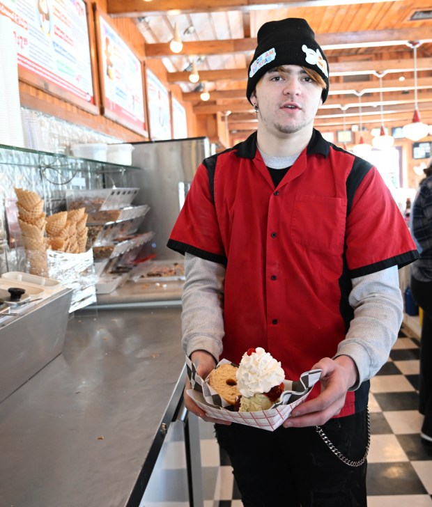 Dylan Garcia creates a doughnut sundae Saturday, Feb. 7, 2026, at Inside Scoop in Coopersburg. The shop featured special ice cream dishes to celebrate National Ice Cream for Breakfast Day. (Amy Shortell/The Morning Call)
