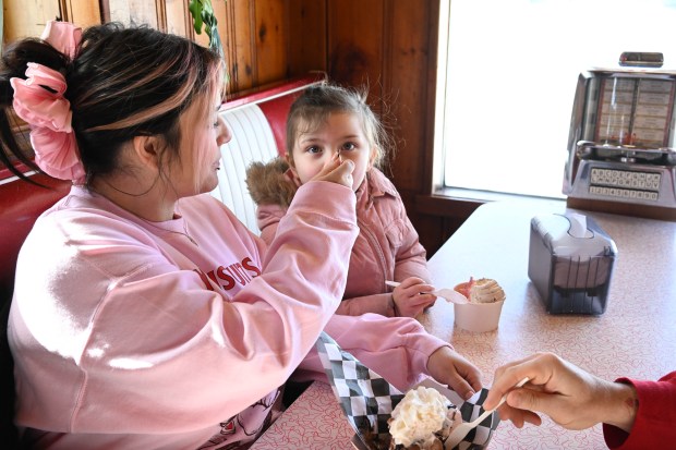 Cassie Velders and her daughter, Luna, 4, enjoy a waffle sundae and a bowl of ice cream Saturday, Feb. 7, 2026, at Inside Scoop in Coopersburg. The shop featured special ice cream dishes to celebrate National Ice Cream for Breakfast Day. (Amy Shortell/The Morning Call)