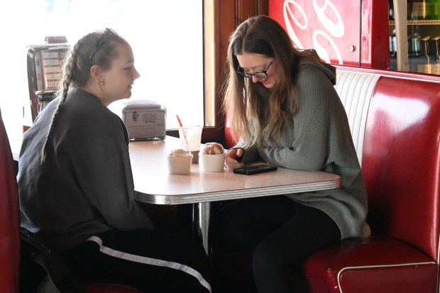 Anya Clark and Karina Clark enjoy ice cream Saturday, Feb. 7, 2026, at Inside Scoop in Coopersburg. The shop featured special ice cream dishes to celebrate National Ice Cream for Breakfast Day. (Amy Shortell/The Morning Call)