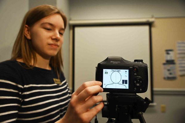 Sairra Cloen, assistant supervisor, sets up a specialized camera for taking passport photos at the Boyertown Community Library, 24 N. Reading Ave. Nonprofits such as the library will no longer be authorized to provide passports. (BILL UHRICH/READING EAGLE)